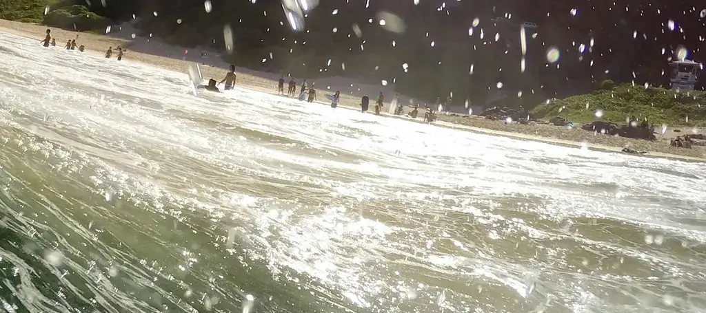 Close-up of real white water and spray droplets inside a breaking wave